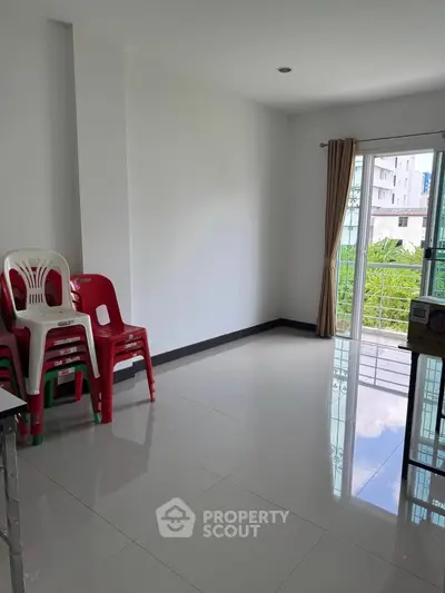 Spacious unfurnished room with balcony access and tiled flooring, ideal for customization.