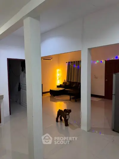 Spacious living area with modern decor and ambient lighting