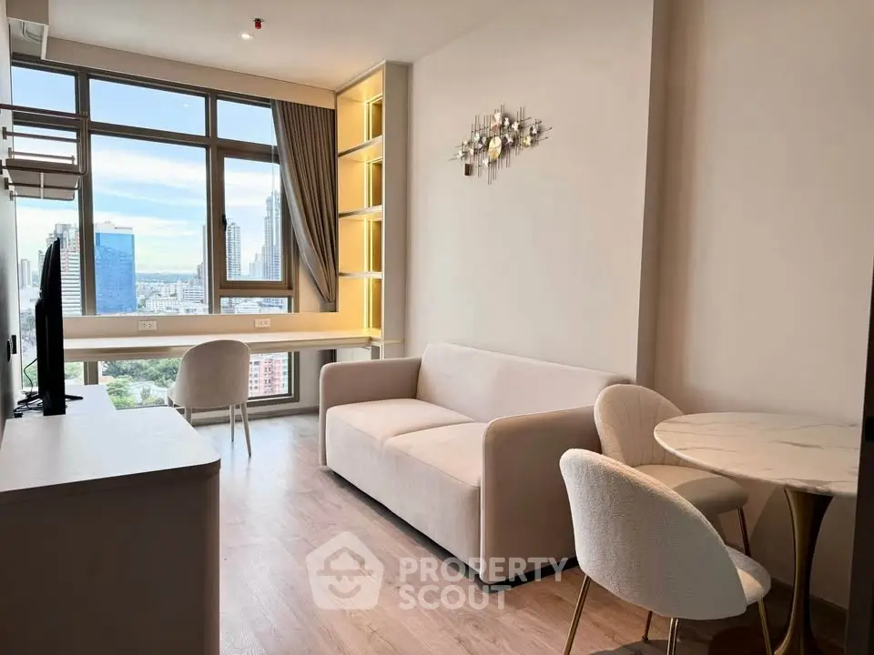 Modern living room with city view, featuring sleek furniture and large windows.