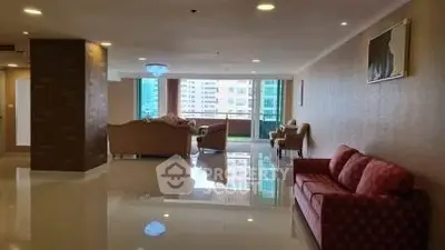 Spacious living room with elegant furniture and city view, perfect for modern urban living.