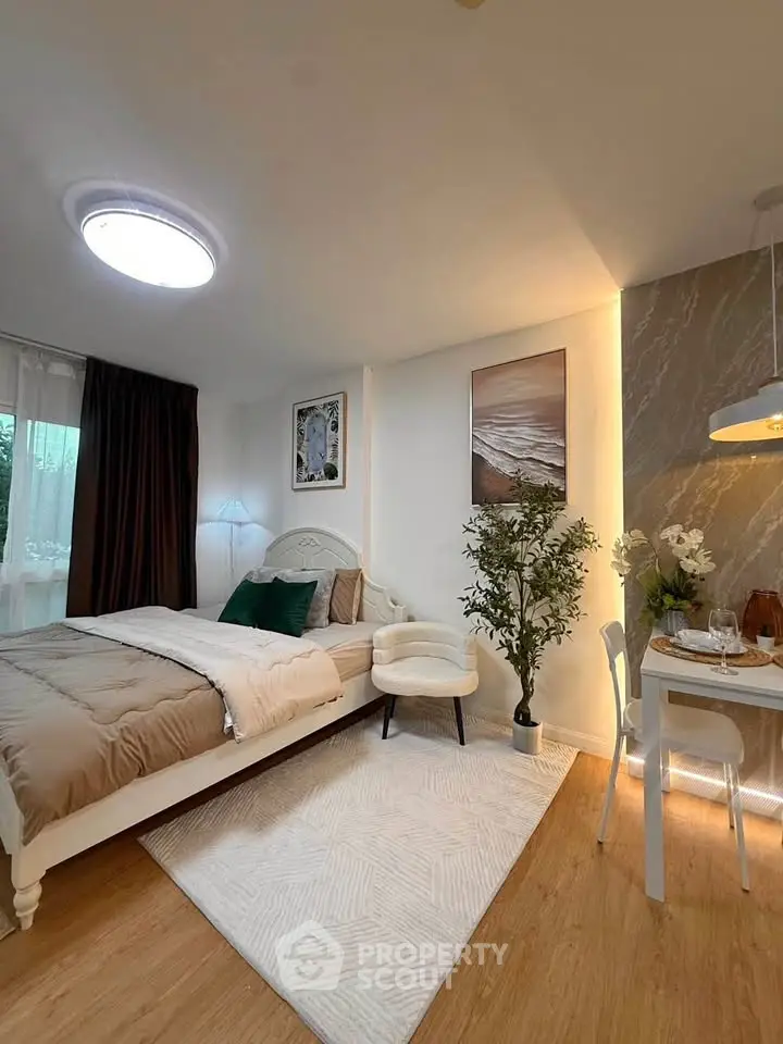 Cozy bedroom with elegant decor and dining area, featuring warm lighting and stylish furnishings.