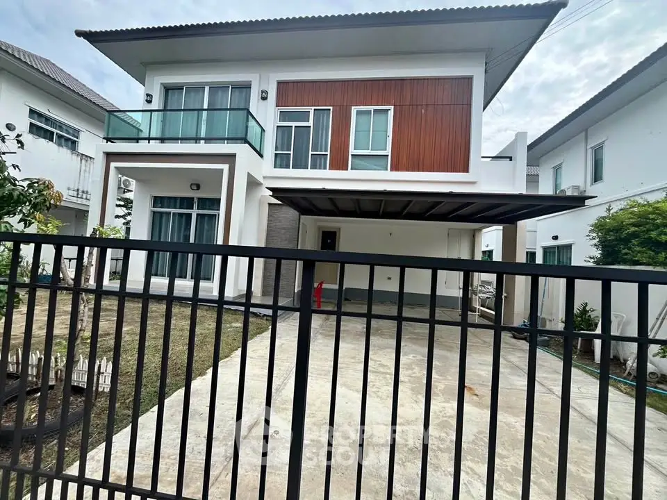 Modern two-story house with spacious driveway and stylish facade in a serene neighborhood.