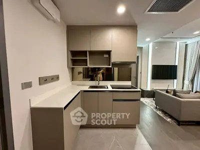 Modern open-layout kitchen with sleek cabinetry and integrated appliances