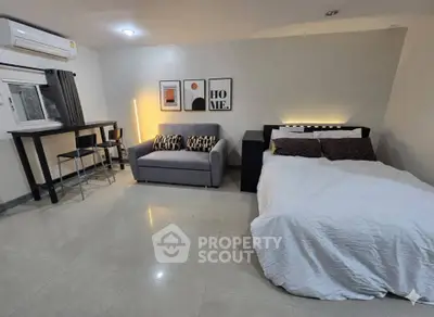 Modern studio apartment with cozy bed and stylish decor