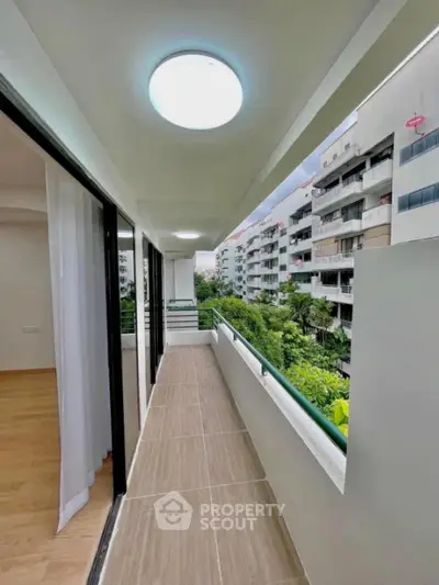 Spacious balcony with modern lighting and scenic view in urban apartment