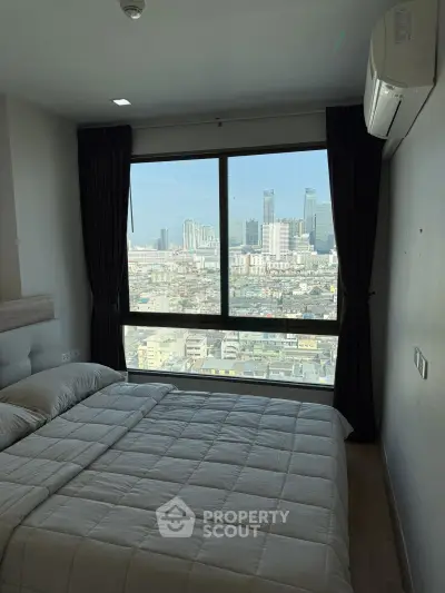 Modern bedroom with large window offering stunning cityscape views, featuring cozy bedding and air conditioning.