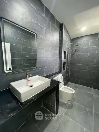 Modern bathroom with sleek gray tiles and contemporary fixtures