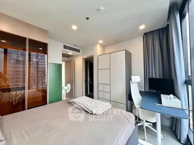 Modern bedroom with large windows and sleek furniture in urban apartment