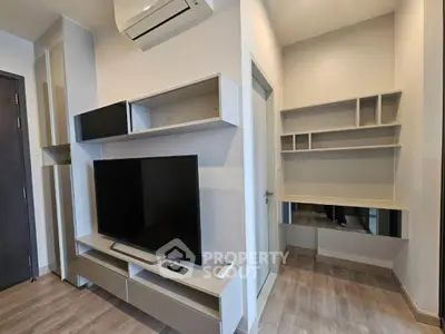 Modern living room with sleek TV unit and air conditioning, featuring a stylish study nook.