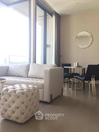 Luxurious modern living room with elegant furniture and large windows offering stunning views.