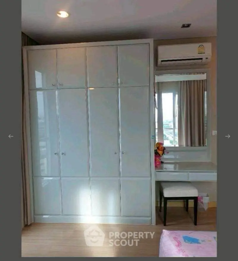 Spacious bedroom with built-in wardrobe and vanity area, perfect for modern living.