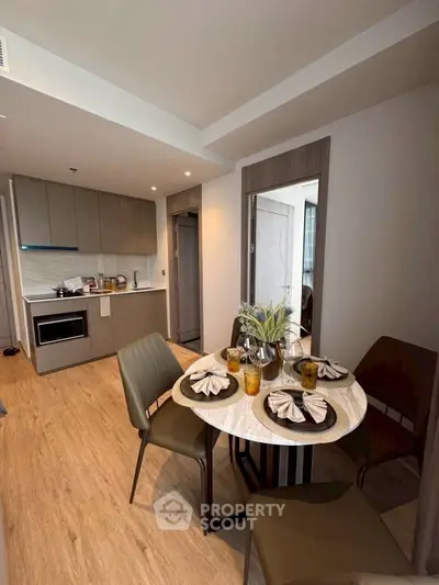 Modern kitchen and dining area with stylish decor and wooden flooring