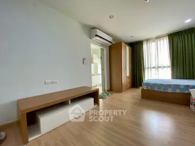 Spacious bedroom with modern furnishings and natural light