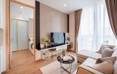 Modern living room with large windows and stylish decor in a contemporary apartment.