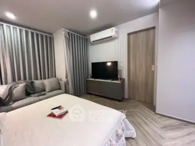 Modern bedroom with cozy bed, sleek TV setup, and stylish decor for ultimate relaxation.