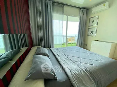 Luxurious bedroom with modern decor and balcony access, featuring stylish bedding and elegant wall art.