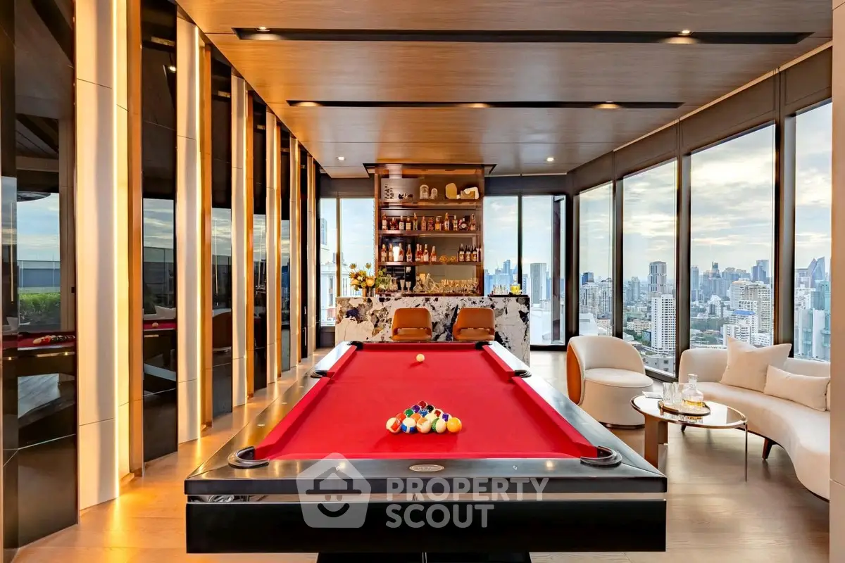 Luxurious penthouse with stunning city views and elegant interior design featuring a pool table and modern bar area.
