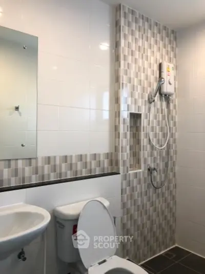 Modern bathroom with stylish tile design and shower unit