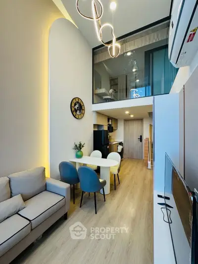 Modern loft apartment with stylish decor and open layout, featuring a cozy living area and dining space.