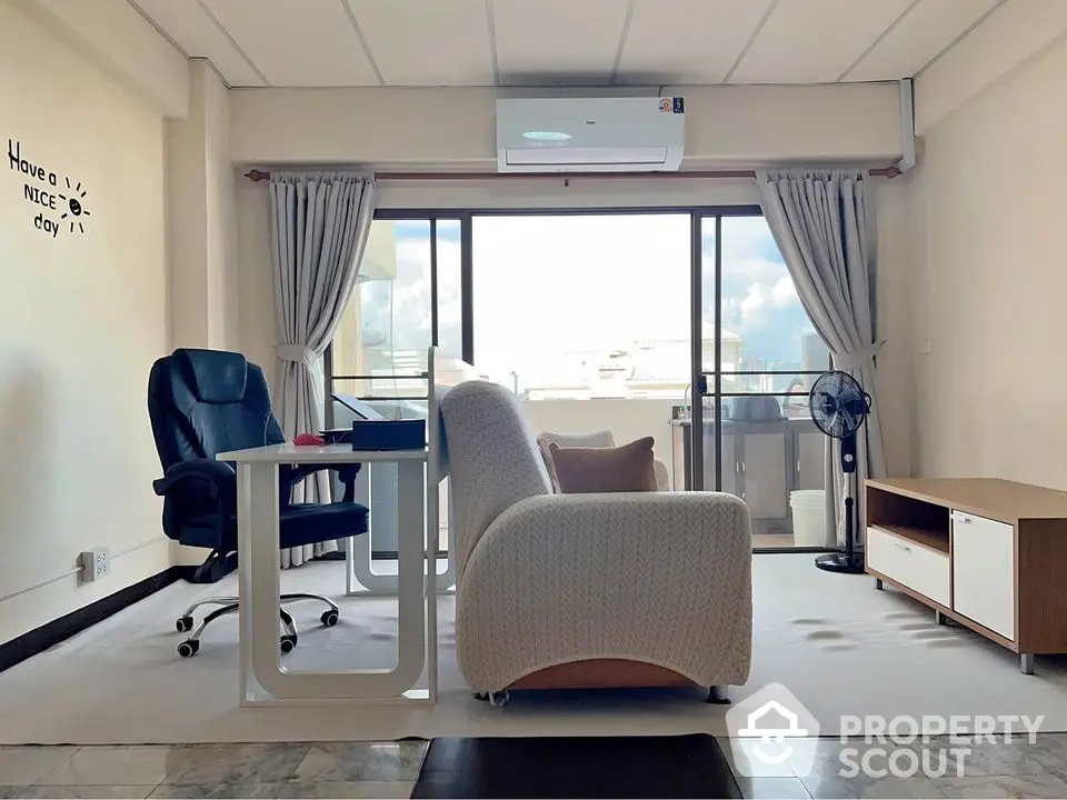 Spacious living room with modern furniture and balcony view