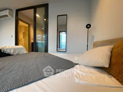 Modern bedroom with stylish decor and large window view