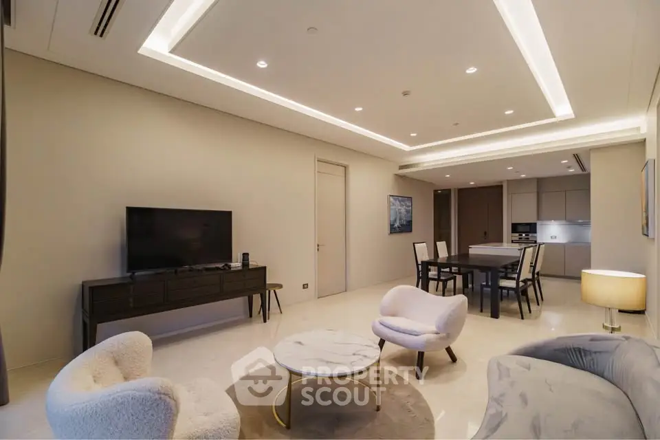 Luxurious modern living room with elegant furniture and open kitchen layout, perfect for entertaining.
