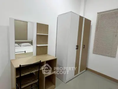 Modern bedroom with sleek wardrobe and stylish desk setup