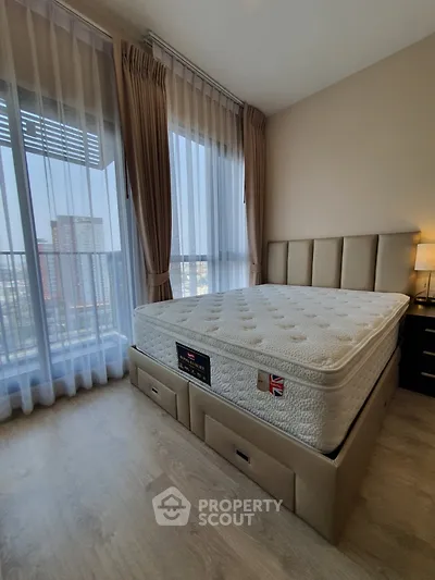 Modern bedroom with large windows and stylish bed in high-rise apartment