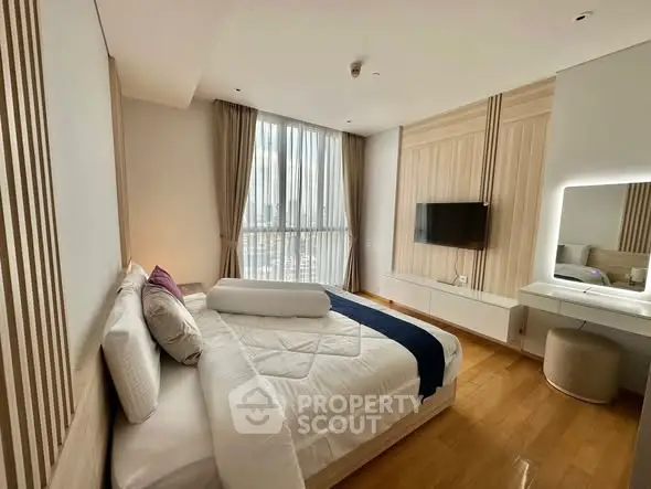 Luxurious bedroom with modern decor, large window, and stylish furnishings in a high-rise apartment.