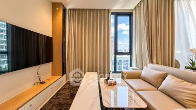 Luxurious modern living room with large TV and elegant furnishings