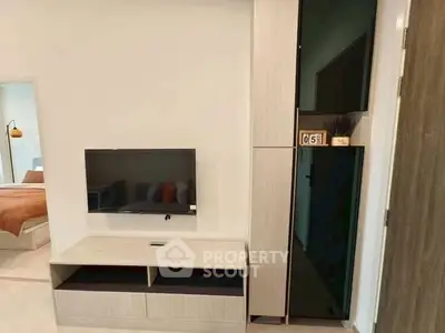 Modern living room with wall-mounted TV and stylish storage unit