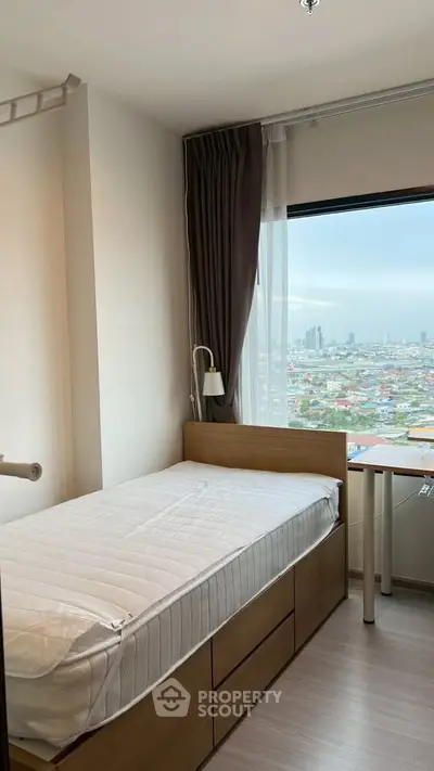 Cozy bedroom with city view, featuring a single bed and modern decor, perfect for urban living.