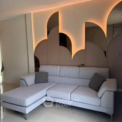 Modern living room with stylish sofa and unique wall lighting design