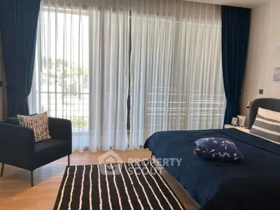 Elegant bedroom with large windows and stylish decor