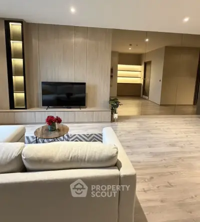 Spacious modern living room with elegant wooden flooring and stylish furniture