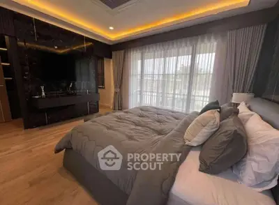 Luxurious bedroom with elegant decor and large windows for natural light.