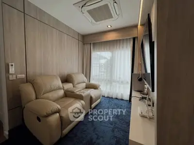 Cozy living room with plush leather recliners and large window for natural light.