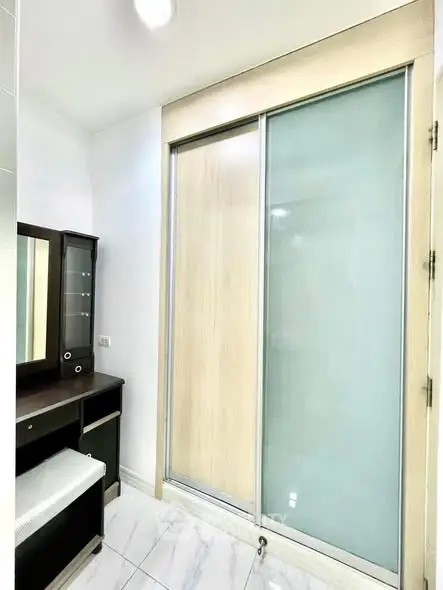 Modern interior with sliding closet doors and vanity in a bright room