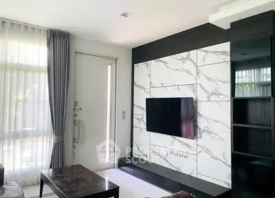 Modern living room with marble accent wall and sleek TV setup