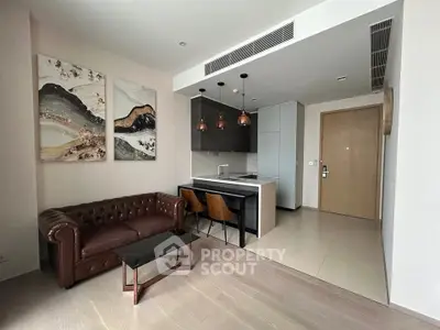 Modern open-layout living room with stylish kitchen and elegant decor