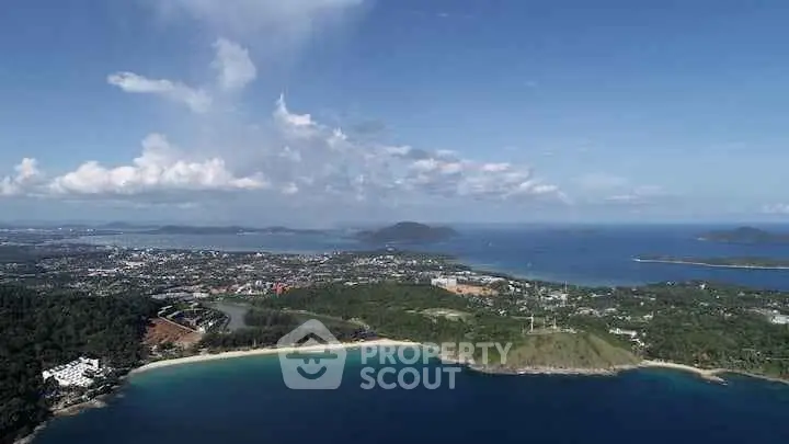 Stunning aerial view of coastal landscape with lush greenery and pristine beaches, perfect for real estate investment.
