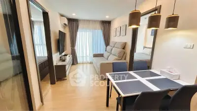 Modern living room with dining area, stylish decor, and natural light.