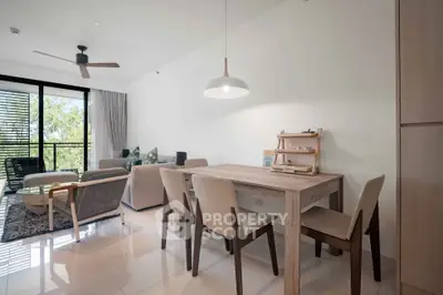 Modern open-plan living and dining area with stylish furniture and natural light.