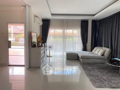 Spacious living room with modern decor and large windows for natural light