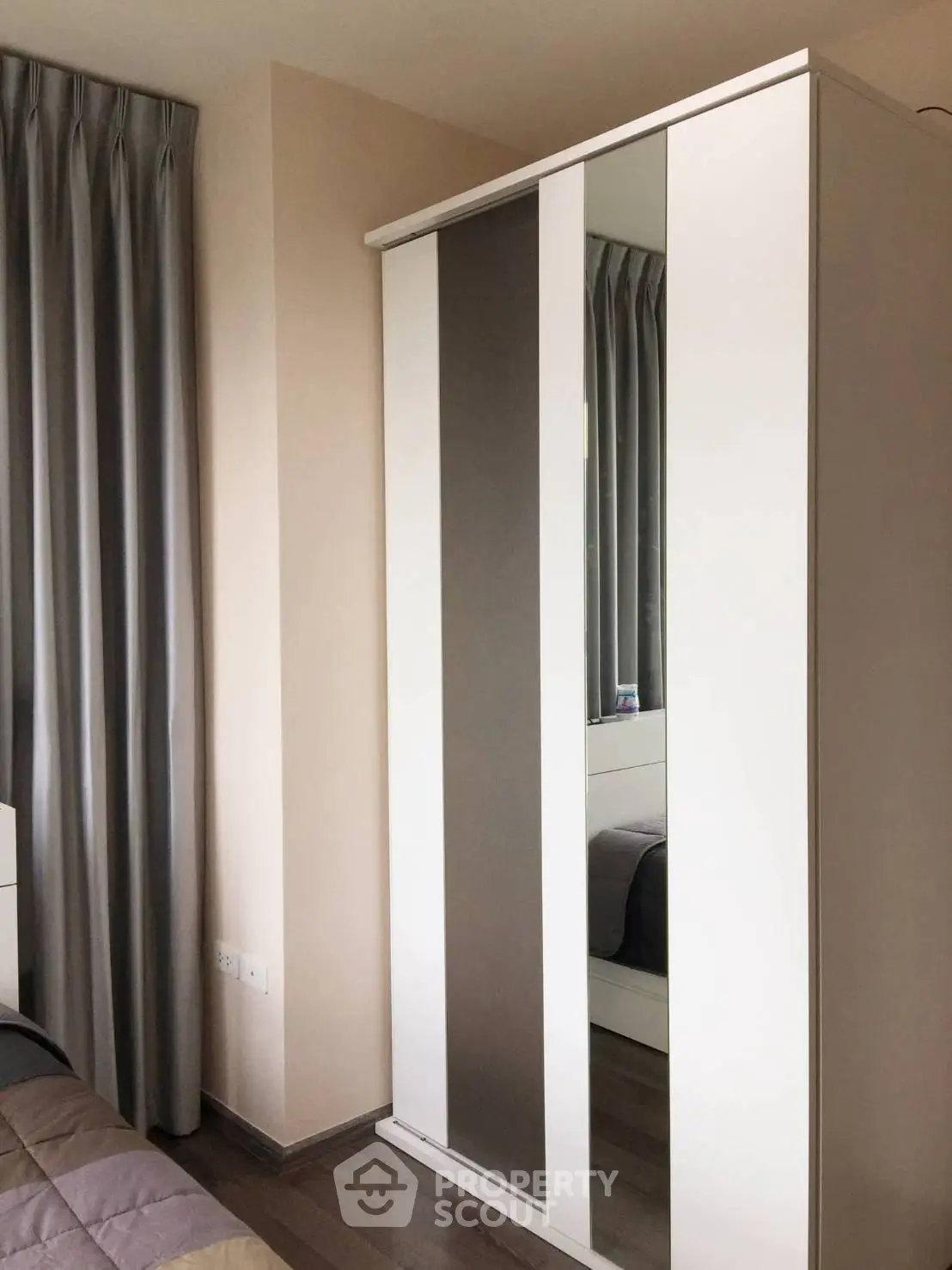 Modern bedroom with sleek wardrobe and elegant curtains