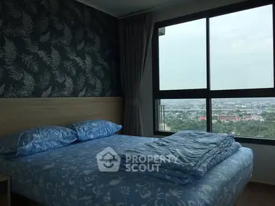 Modern bedroom with large window offering stunning city view and stylish decor.