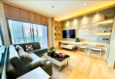 Luxurious modern living room with stylish decor and city view, featuring cozy seating and elegant lighting.