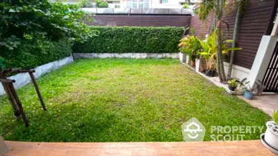 Charming private garden with lush greenery and privacy fence, perfect for outdoor relaxation and entertainment.