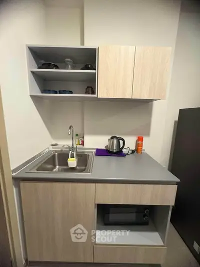 Compact modern kitchen with sleek cabinetry and stainless steel sink