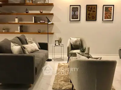 Elegant living room with modern gray sofas, stylish decor, and warm lighting.